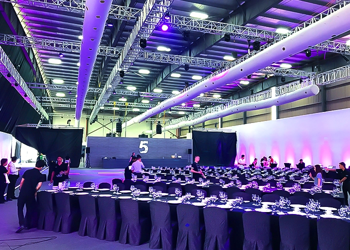 The interior view of an indoor event with a large-scale chiller rental setup of equipment and decorations.