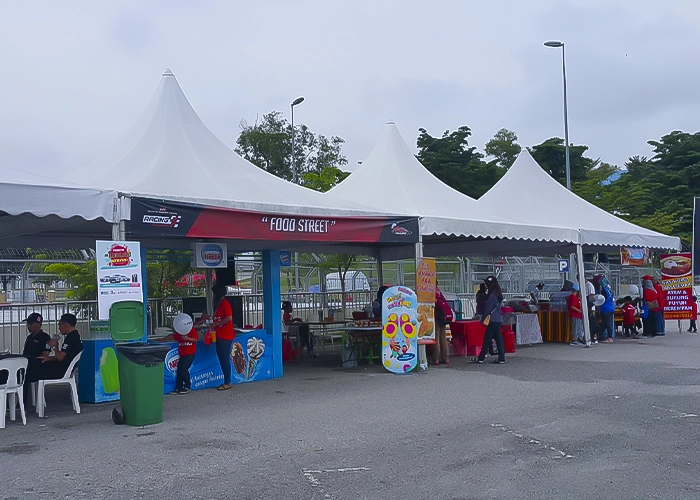 An outdoor setup of rental tent units at a parking lot.