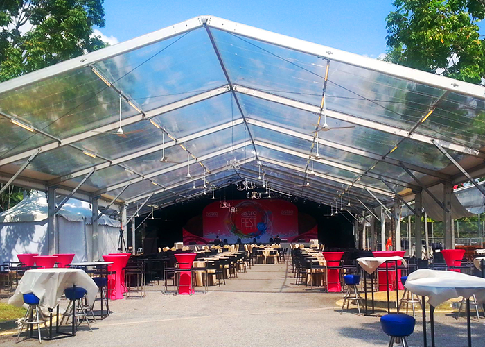 A display of TK Rentals’ tent rental setup with a large width fitting multiple furniture within.